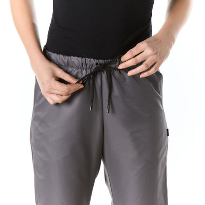 Mujer vistiendo pantalon sanitario tipo jogger gris slim fit con elastico en cintura