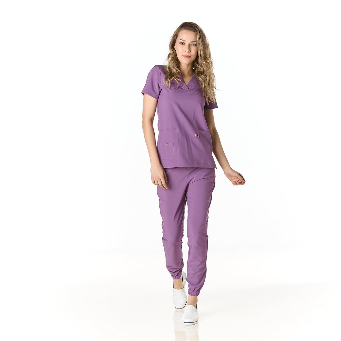 Mujer vistiendo pijama sanitario color morado con cuello en v y pantalon tipo jogger - frontal